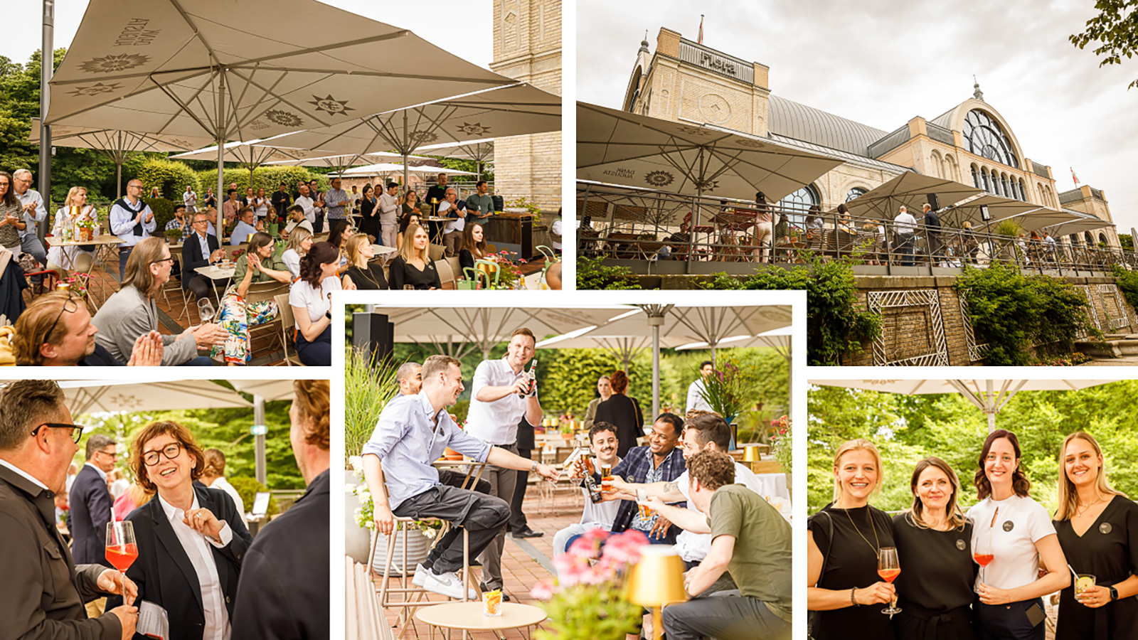 Menschen treffen sich im Freien unter Sonnenschirmen bei einer lebhaften Veranstaltung in der Nähe eines großen, historisch anmutenden Gebäudes.